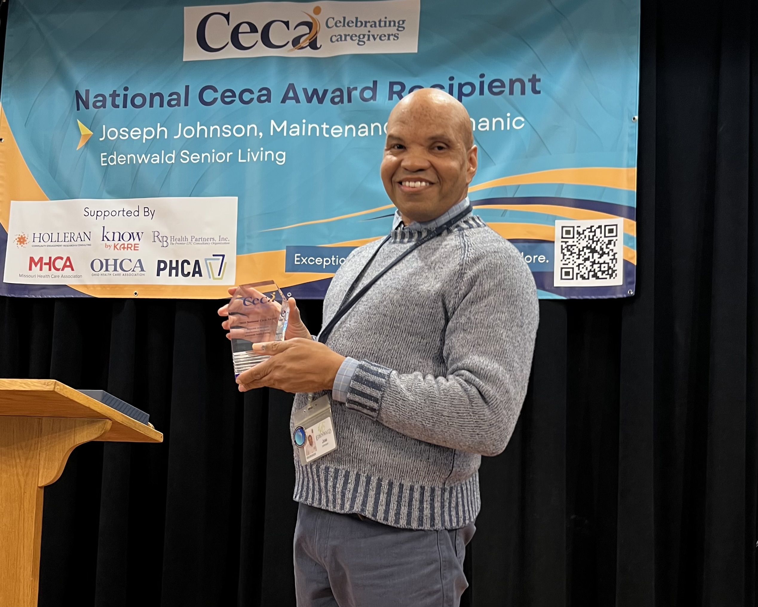 Maintenance Mechanic Joseph Johnson holds his award from the Ceca Foundation honoring his exemplary service to the Edenwald community.