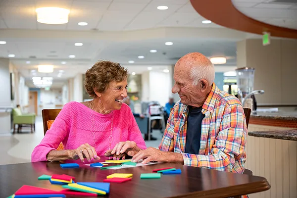 Edenwald_Health-Services_Memory-Care A senior couple sitting at a table participating in memory exercises