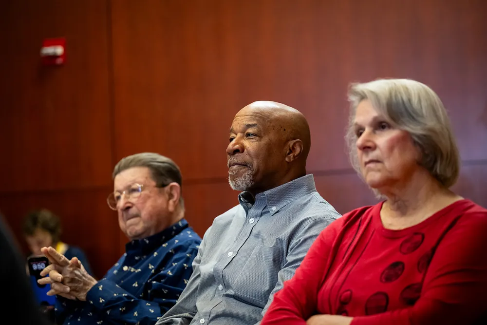 Three seniors listening to a lecture