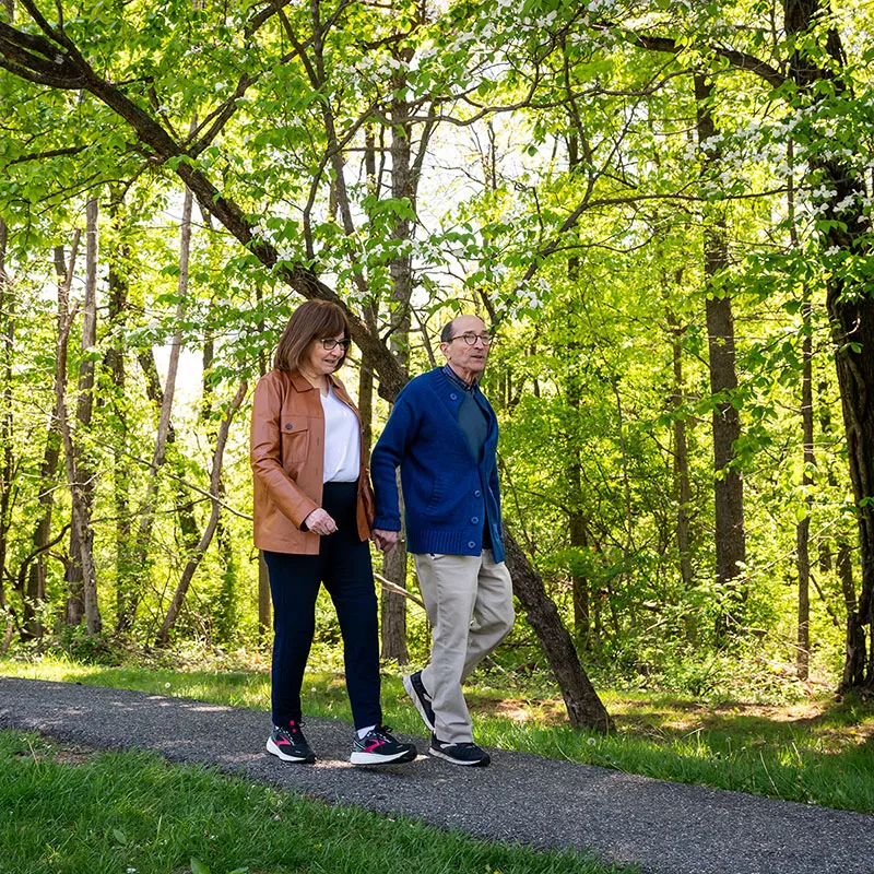 Edenwald_Mission-Values_1 A senior couple taking a walk in a park