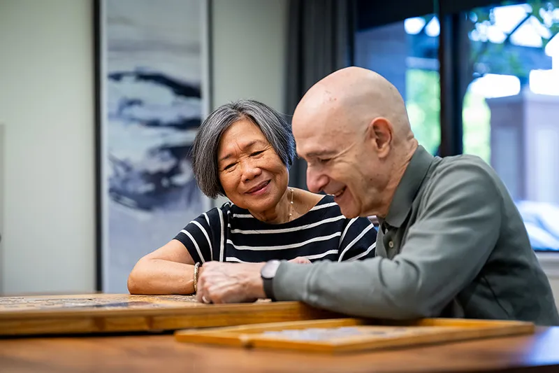 Edenwald_Mission-Values_2 An older couple playing a game in a senior center