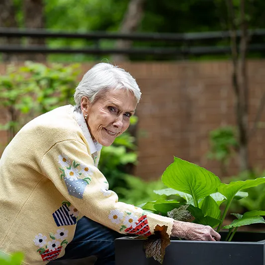 Edenwald_Programs-Events_arts-culture-interests A senior woman working in a garden