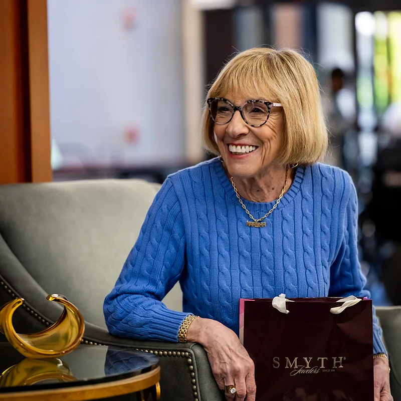 Edenwald_Residential-Services-Amenities_2 A woman holding a bag from Smyth Jewelers on her lap