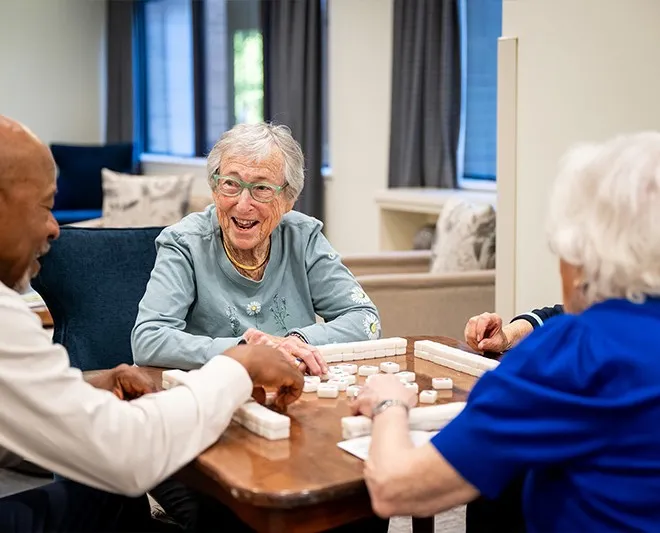 Edenwald_Residents-Association1 An elderly woman playing a board game with residents