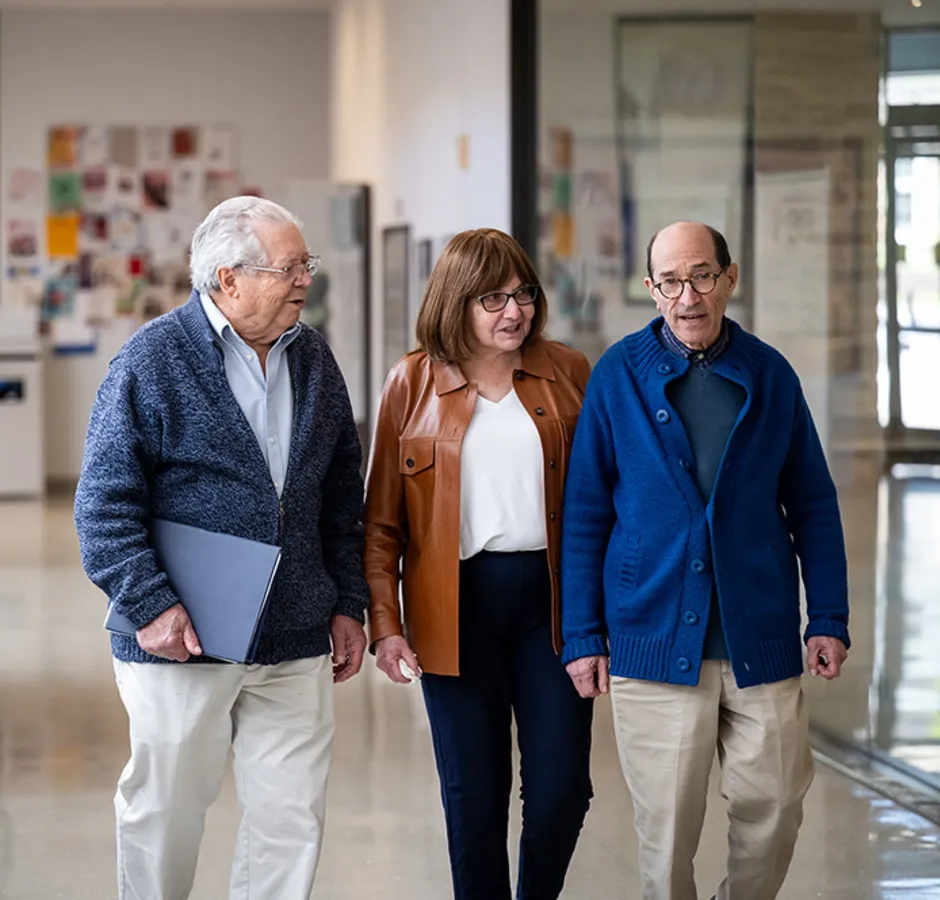 college-enriched Senior couple walking through a hallway